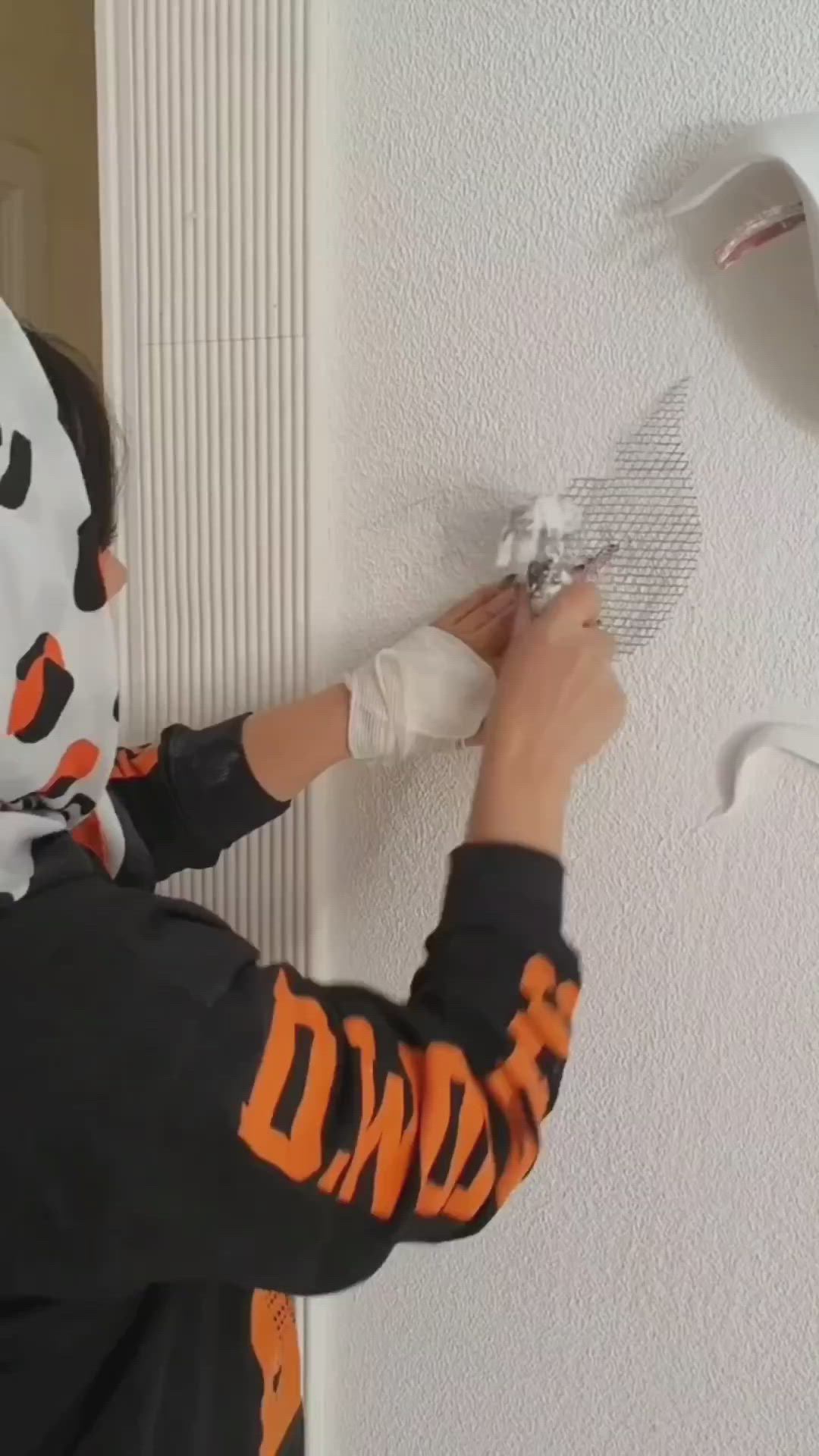 This may contain: a person is painting the ceiling with white paint and paper on it's surface