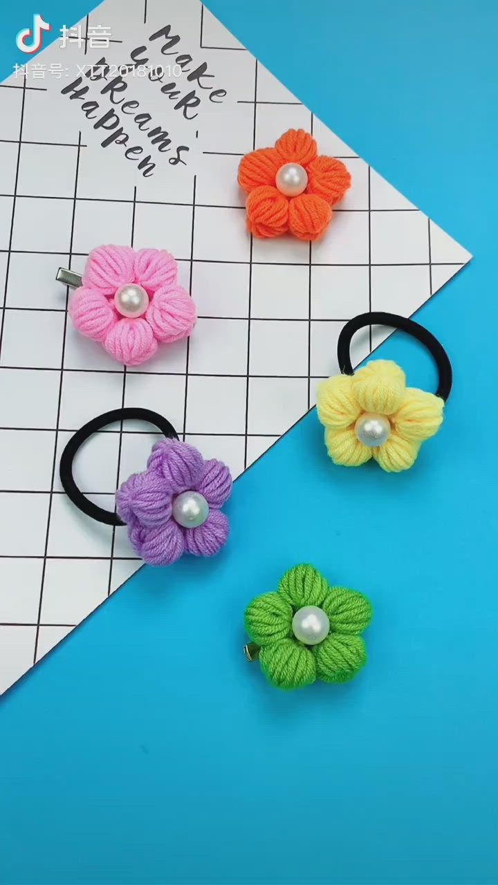 This may contain: four flower hair clips with pearls on each one and two different colored flowers in the middle