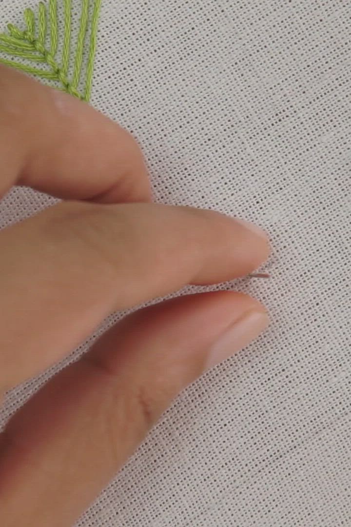 This may contain: someone is stitching the red thread with a needle