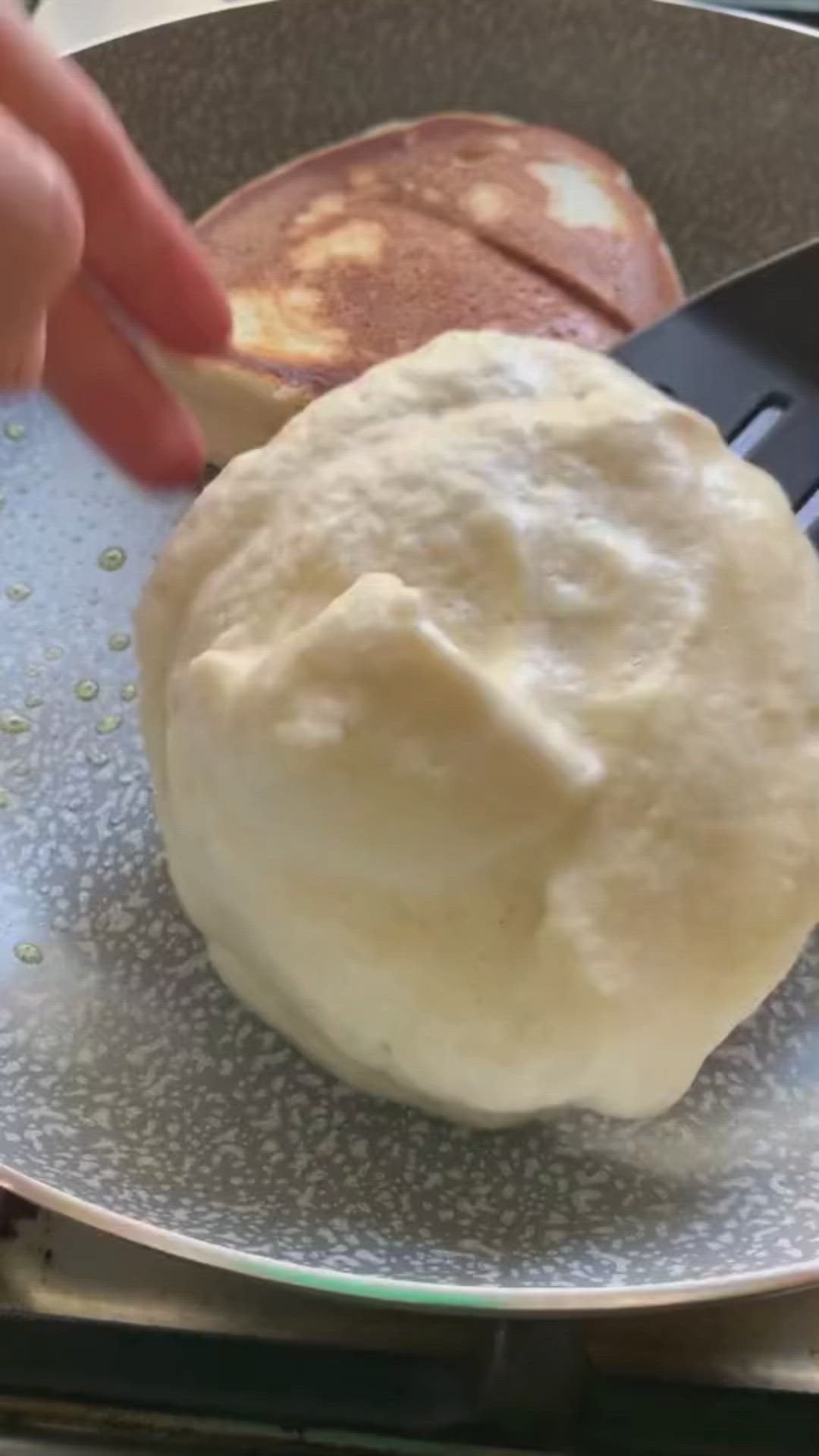 This may contain: two pancakes sitting in a pan on top of a stove