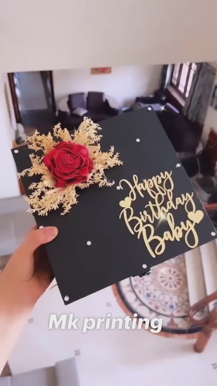 This may contain: someone holding up a card with a rose on it that says happy birthday dad in gold lettering