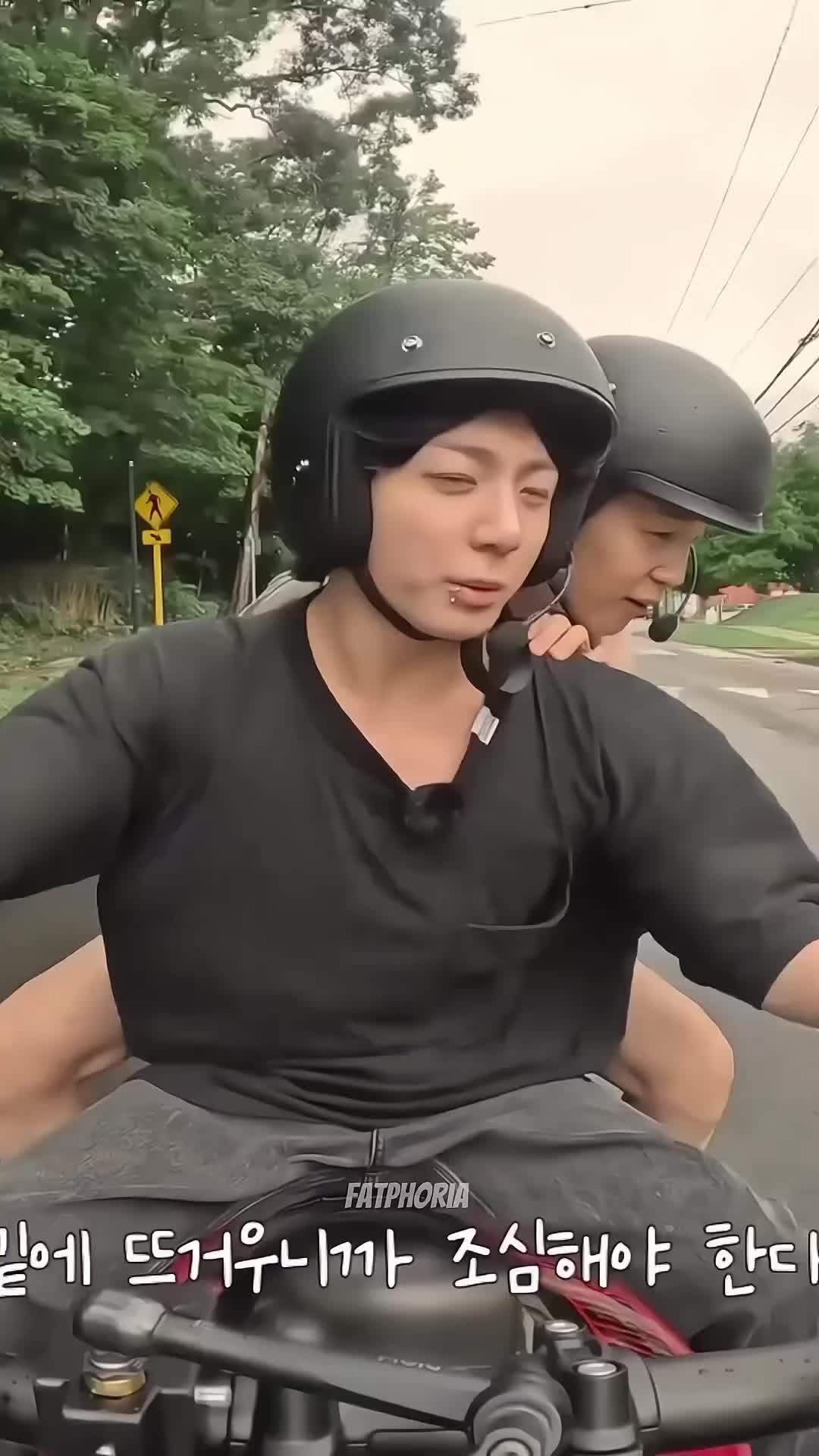 This may contain: two people riding on the back of a motorcycle