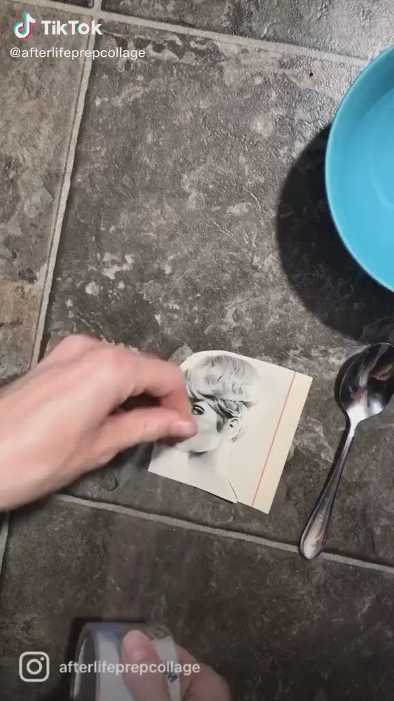 This may contain: a person is cutting paper with scissors on the floor next to a bowl and spoon