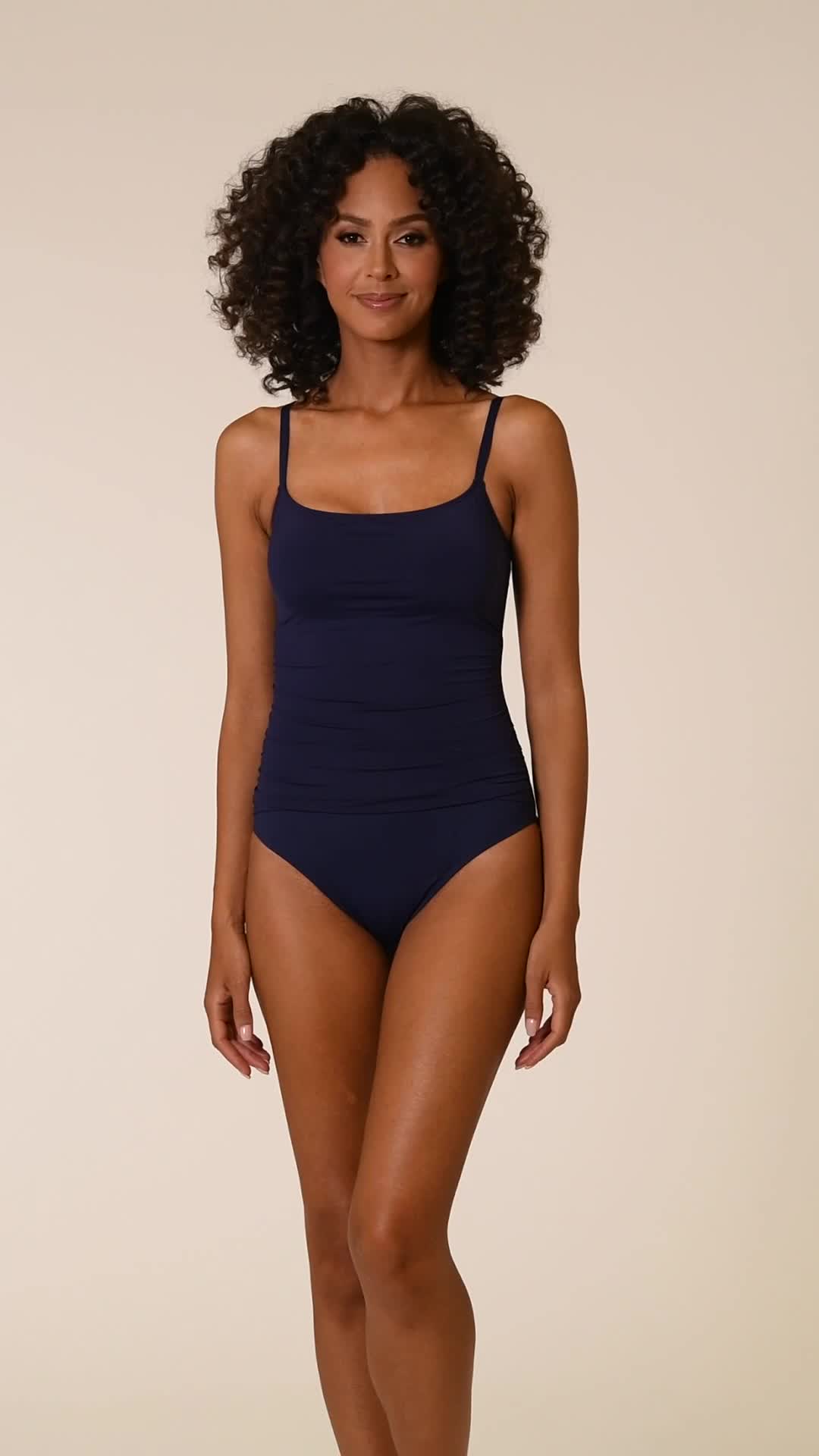 Our sleekly styled one-piece swimsuit proves that less is more. The simple, classic silhouette flatters the figure with allover shirring, while a demi-scoop neckline reveals just the right amount of skin. Guaranteed to be your go-to this season, it holds everything up and in so you can confidently go about your day, whether taking a dip in the pool or bodysurfing in the ocean. [split] Details Demi-scoop neckline Adjustable straps Removable cups Gently shirred for a slimming effect Fabric 83% Nyl