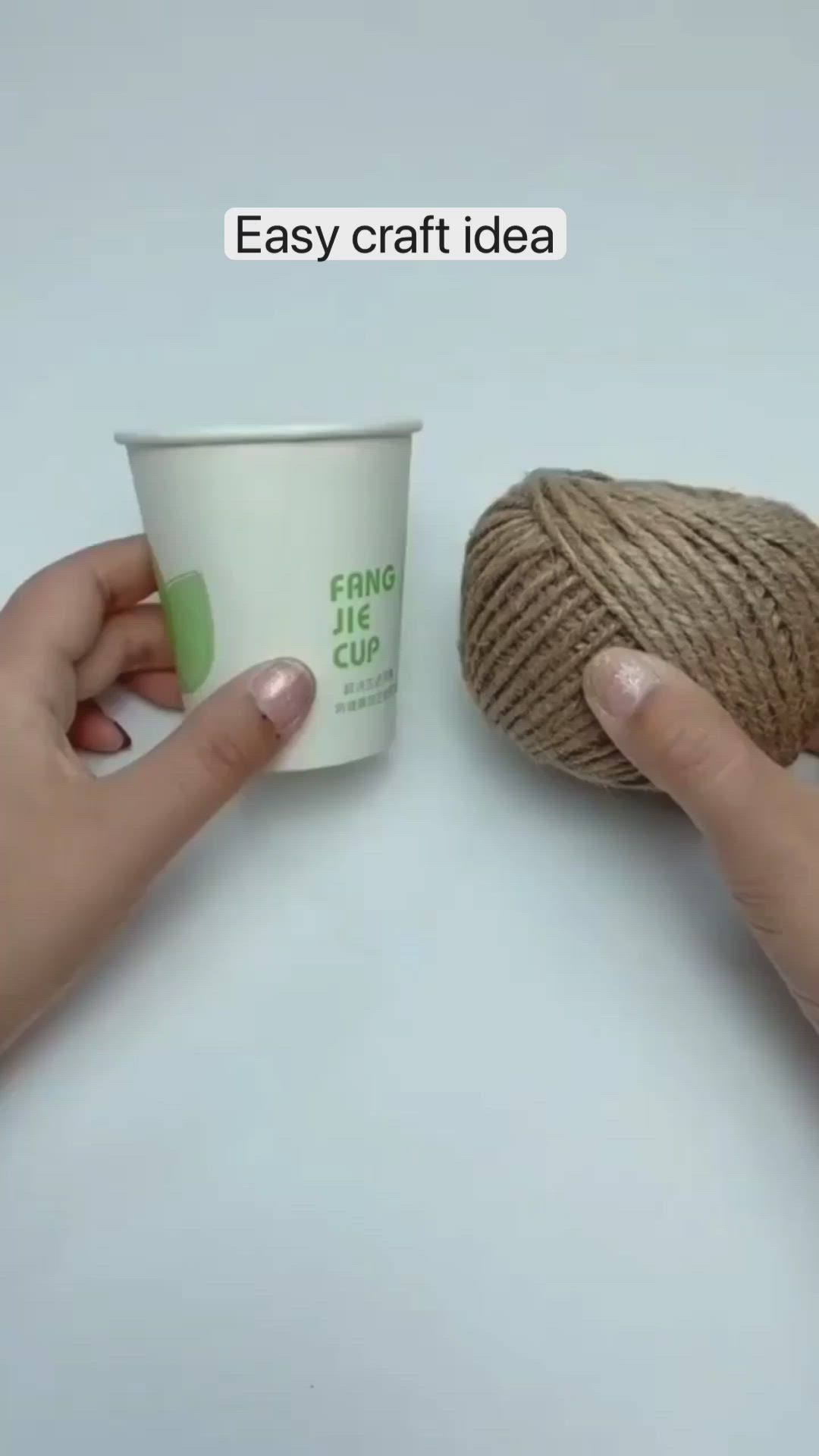 This may contain: two hands holding a yarn ball and a cup of coffee with the text easy craft idea