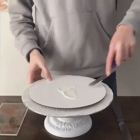 This may contain: a man cutting into a white cake with a knife and fork on top of it