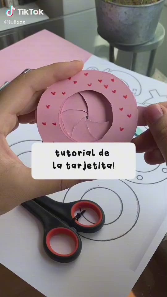 This may contain: someone is making a doughnut out of paper