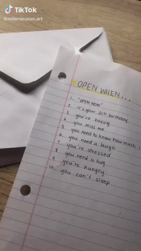 This may contain: someone is writing an open lettered note on a piece of paper that says, open when you opened it all the other letters