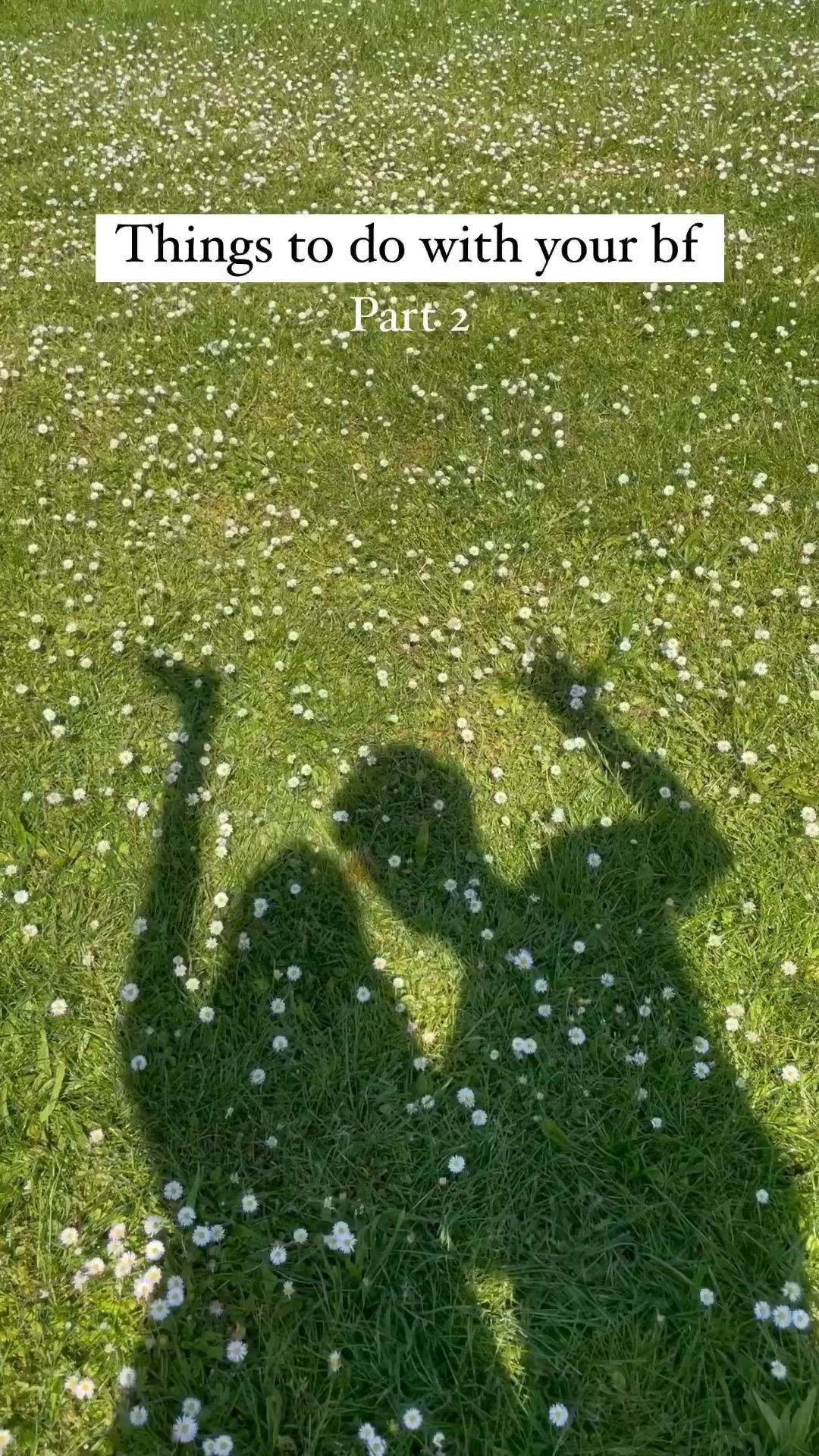 This may contain: a person standing in the grass with their shadow