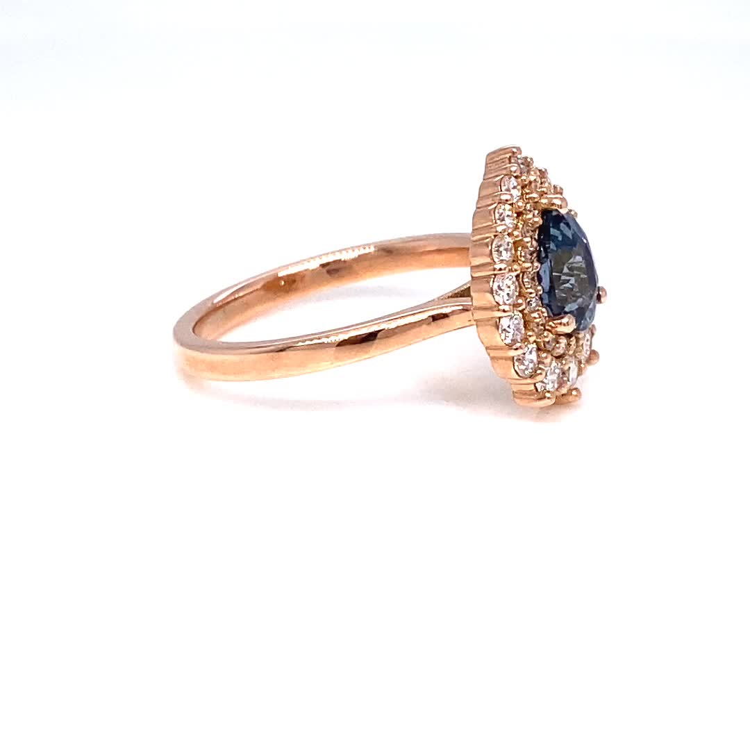 One of a kind ring ~ only One is available! This exquisite peacock blue sapphire engagement ring in a 14k rose gold double halo diamond ring features a 1.15-carat pear-shaped natural blue sapphire. The unique blue hue of the sapphire is perfectly complemented by the warm tones of rose gold, while the surrounding white diamonds add a touch of sparkle and luxury. With its gorgeous color and elegant design, this sapphire diamond ring is the perfect choice for brides looking for a non-traditional an