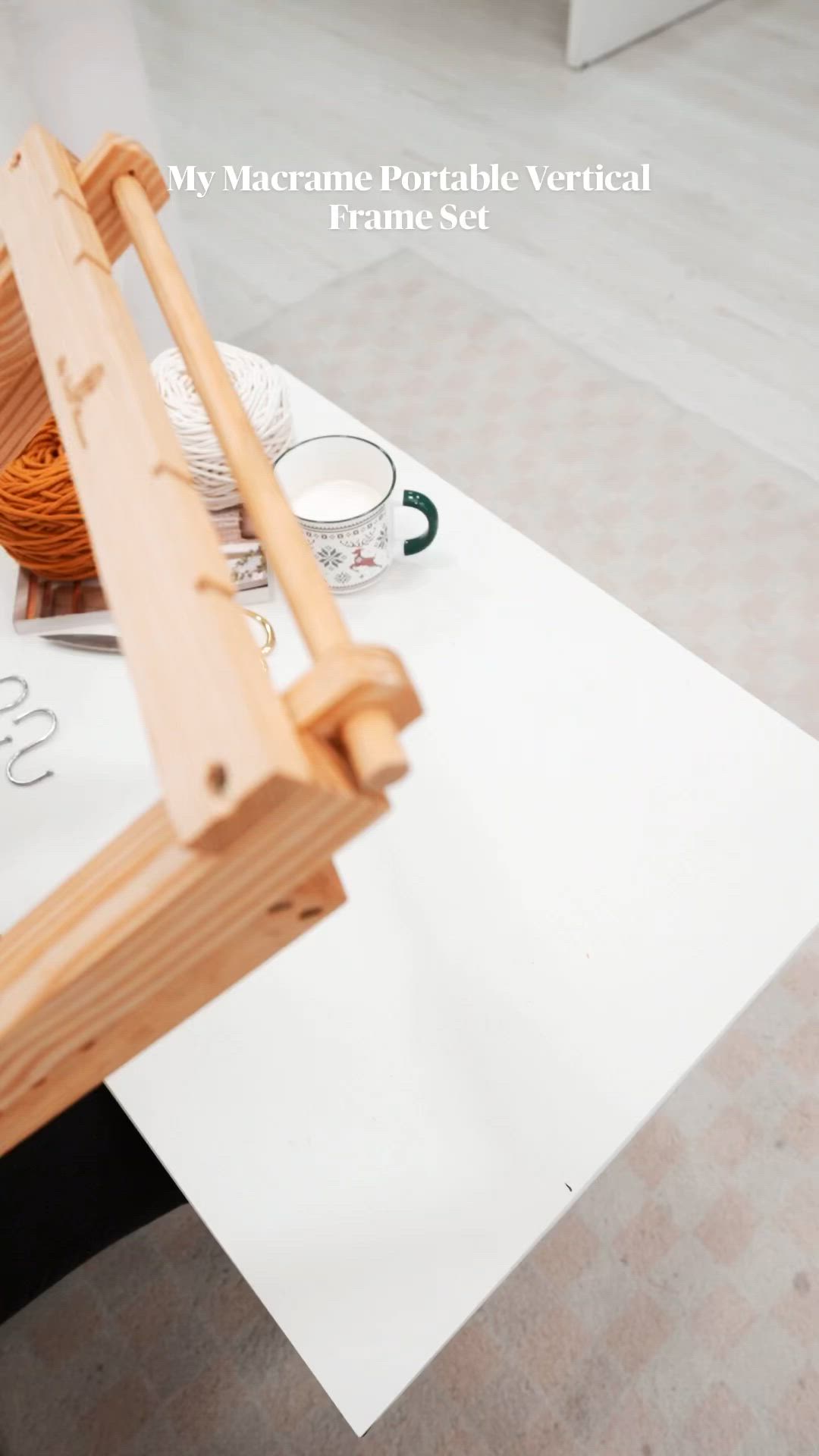 This may contain: a woman is weaving on an old wooden loom with her hands and the text, my macrame portable vertical frame set