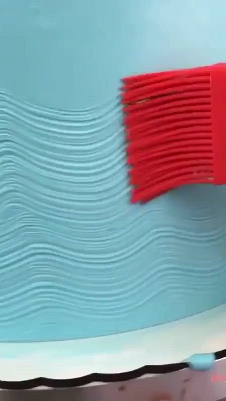 This may contain: a blue and white wall with waves painted on it, next to a red brush