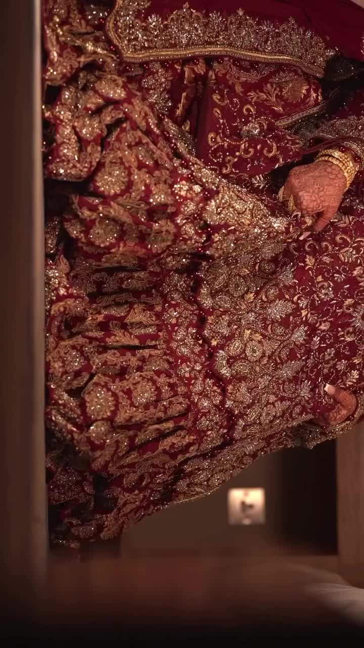 This may contain: a woman in a red and gold wedding dress