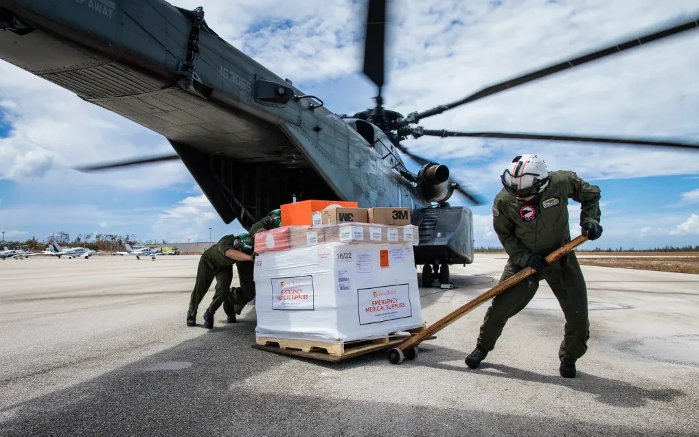 Emergency responders unload medical aid from a helicopter.