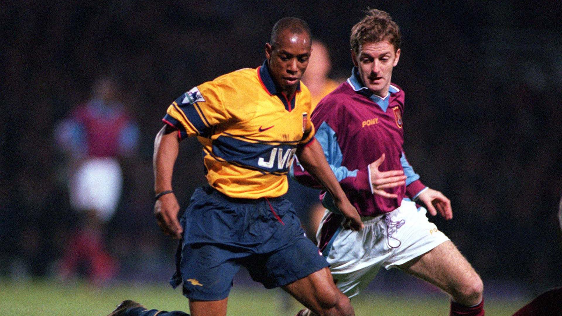 Ian Wright of Arsenal and Keith Rowland of West Ham battle for possession