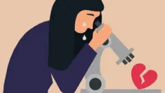 A woman looks at a broken heart through a microscope