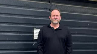 Andy Kulina stands outside the partly-converted garage