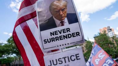 A poster of Donald Trump features the words 'Never Surrender' and 'Justice for Trump'
