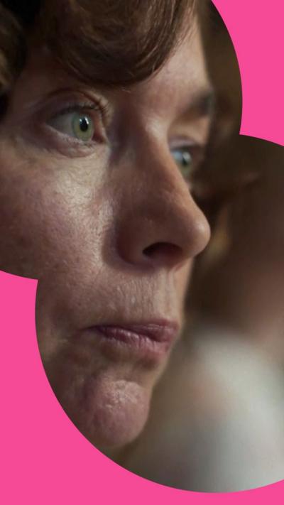 Character Kate Galloway looks disapprovingly - she has curly dark hair