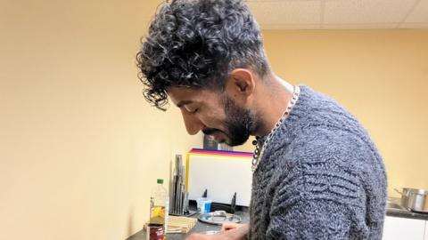 A man chopping food in a kitchen