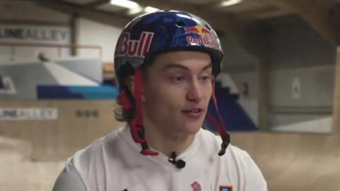 Kieran Reilly wearing a helmet and sitting on this bike