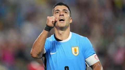 Luis Suarez celebrates scoring in the penalty shootout for Uruguay