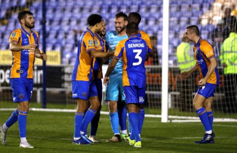 Shrewsbury's players celebrated reaching the EFL Cup second round with keeper Toby Savin