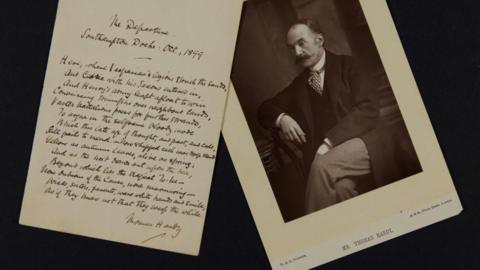 Thomas Hardy's The Departure in fountain pen handwriting next to a black and white photo of the author