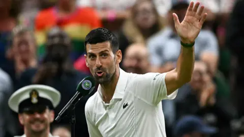 Novak Djokovic waves to the crowd