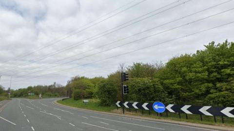 The A690 Herrington Interchange. It is a four-lane road with traffic lights.