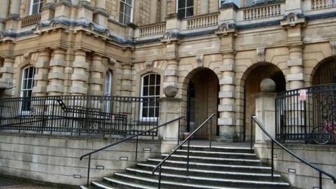 Exterior view of Reading Crown Court with steps up to arched entrance to the building