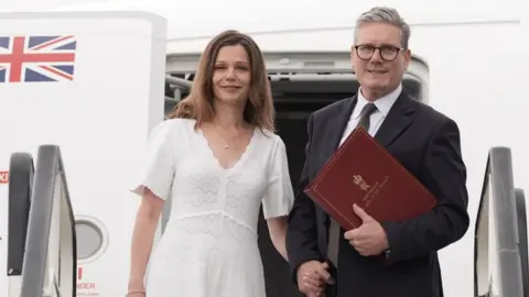 Prime Minister Sir Keir Starmer and his wife Victoria board a plane at Stansted Airport in Essex as they head to Washington D