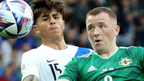 NI striker Shayne Lavery beats Greece's Lazoros Rota in June's game at Windsor Park