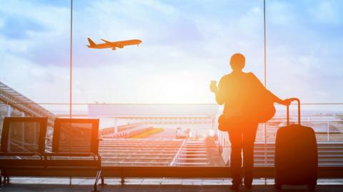 Woman looking at a plane in an airport