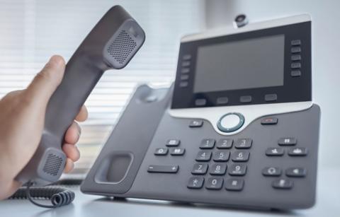 Dialing a telephone in the office concept for communication, contact us and customer service support 