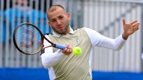 Daniel Evans of Great Britain plays a forehand