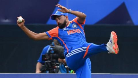 India's Mohammed Siraj braces for landing after taking a catch against USA