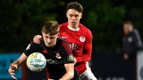 Action from Larne v Crusaders