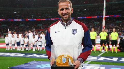 Harry Kane holds his 100th England cap