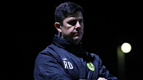 Caernarfon Town boss Richard Davies looks on