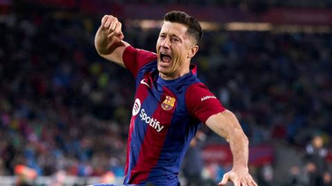 Robert Lewandowski celebrates scoring a hat-trick against Valencia