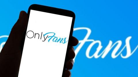 A person holding a phone with an OnlyFans logo on it