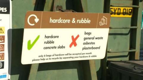 A recycling centre sign which reads 'hardcore and rubble'