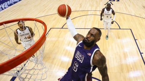 Team USA star LeBron James winds up for a dunk against South Sudan