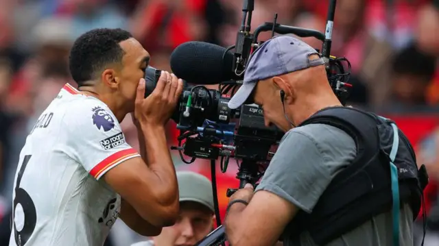 Trent Alexander Arnold kisses a TV camera after thinking he had opened the scoring for Liverpool at Manchester United - only for the goal to then be disallowed for offside