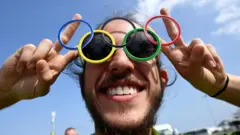 A man wearing olympic ring glasses