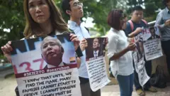 Victims' relatives and their supporters protest against the suspension of the search