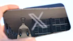 Imagem de celular com símbolo do X e reflexo da estátua A Justiça, em frente ao prédio do STF, em Brasília