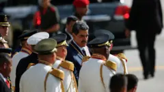 Maduro, um homem branco, de cabelos grisalhos e bigode, está no meio de vários homens vestidos com uma roupa formal branca e boina