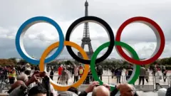 Aros olímpicos com Torre Eiffel ao fundo